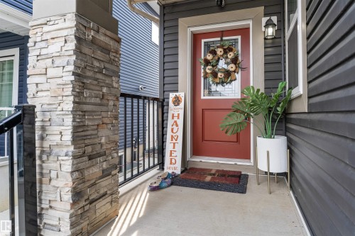 View of exterior entry featuring stone siding - 3607 46 Avenue, Beaumont, AB - Outdoor With Exterior