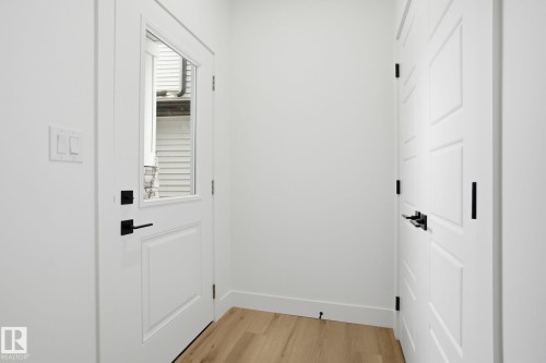 Doorway to outside featuring wood finished floors and baseboards - 2408 208 Street, Edmonton, AB - Indoor Photo Showing Other Room