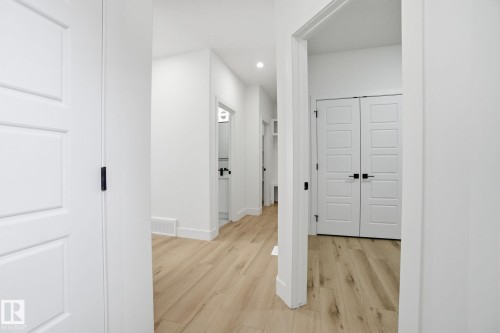 Hall featuring light wood finished floors and recessed lighting - 2408 208 Street, Edmonton, AB - Indoor Photo Showing Other Room