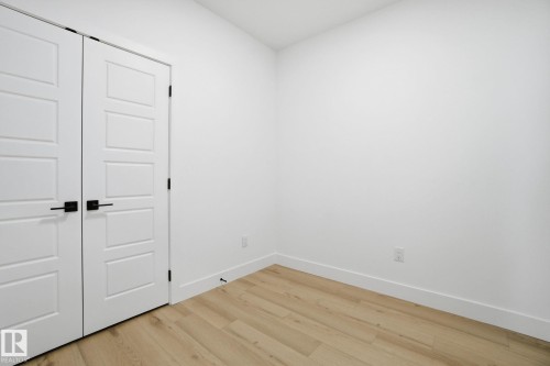 Unfurnished bedroom featuring light wood-style floors and a closet - 2408 208 Street, Edmonton, AB - Indoor Photo Showing Other Room