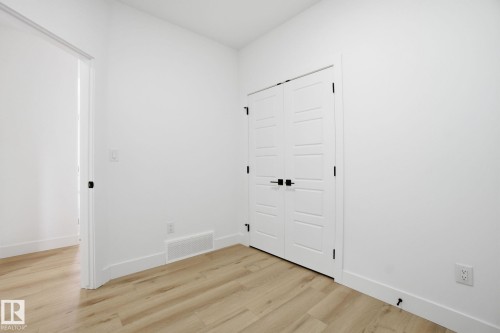 Empty room featuring light wood-style floors and baseboards - 2408 208 Street, Edmonton, AB - Indoor Photo Showing Other Room