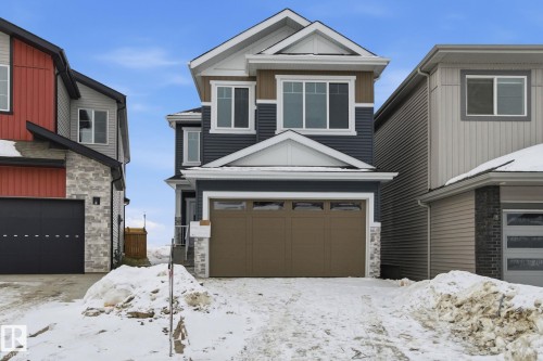 View of front of house featuring stone siding and a garage - 2408 208 Street, Edmonton, AB - Outdoor With Facade