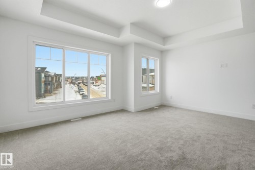 Unfurnished room with a raised ceiling and carpet - 2408 208 Street, Edmonton, AB - Indoor Photo Showing Other Room