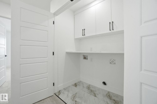 Laundry room with cabinet space, washer hookup, and light marble finish flooring - 2408 208 Street, Edmonton, AB - Indoor Photo Showing Other Room