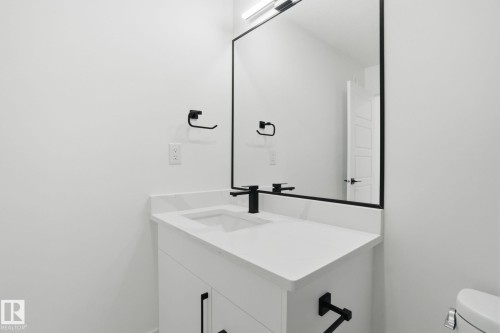 Half bath with vanity and toilet - 2408 208 Street, Edmonton, AB - Indoor Photo Showing Bathroom