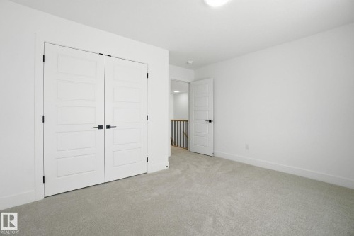 Unfurnished bedroom with light colored carpet and a closet - 2408 208 Street, Edmonton, AB - Indoor Photo Showing Other Room