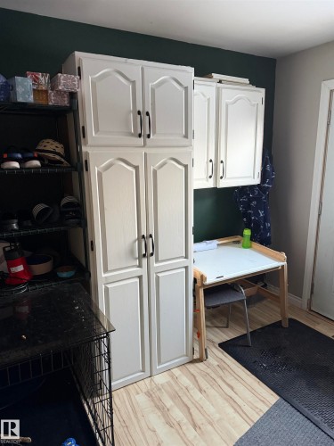Kitchen featuring white cabinetry and light wood finished floors - 4506 53 Avenue, Barrhead, AB - Indoor