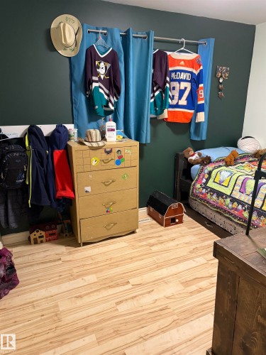 Bedroom featuring wood finished floors - 4506 53 Avenue, Barrhead, AB - Indoor Photo Showing Bedroom