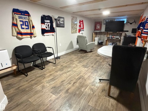 Playroom featuring wood finished floors and baseboards - 4506 53 Avenue, Barrhead, AB - Indoor