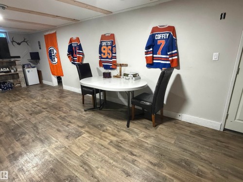 Dining area featuring dark wood-type flooring and baseboards - 4506 53 Avenue, Barrhead, AB - Indoor