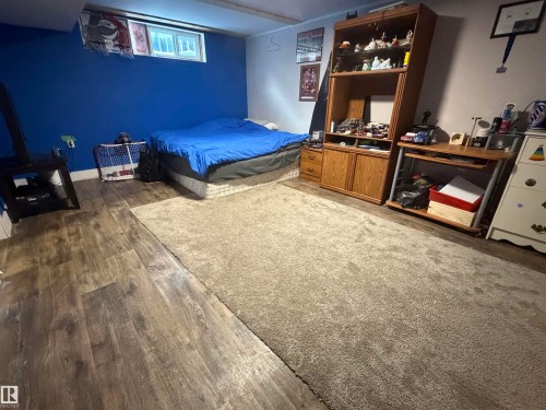 Bedroom with dark wood-type flooring - 4506 53 Avenue, Barrhead, AB - Indoor Photo Showing Bedroom