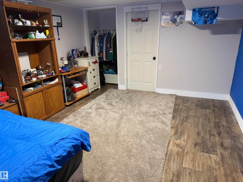 Bedroom featuring wood finished floors and baseboards - 4506 53 Avenue, Barrhead, AB - Indoor