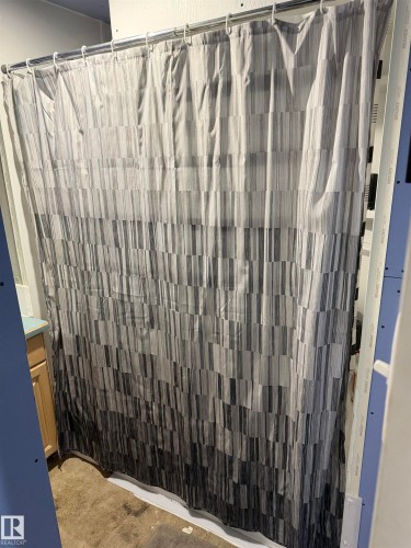 Full bathroom featuring vanity and curtained shower - 4506 53 Avenue, Barrhead, AB - Indoor With Storage