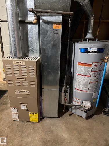 Utility room with gas water heater and heating unit - 4506 53 Avenue, Barrhead, AB - Indoor Photo Showing Basement