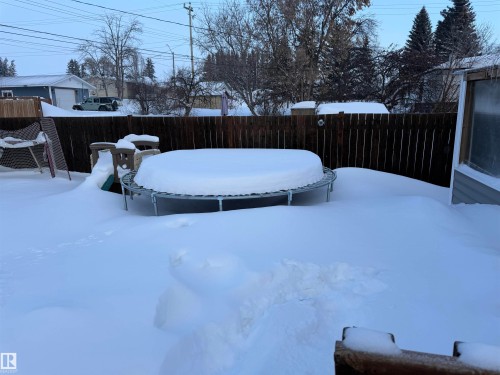 Fenced backyard featuring a swimming pool - 4506 53 Avenue, Barrhead, AB - Outdoor