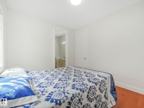 Bedroom with wood-type flooring and ensuite bathroom - 120 38 Street, Edmonton, AB - Indoor Photo Showing Bedroom