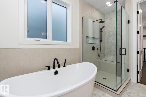 Full bathroom with a freestanding bath and a stall shower - 128 Lilac Close, Leduc, AB 