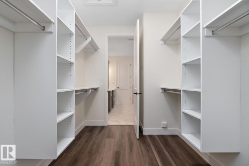 Walk in closet with dark wood finished floors - 128 Lilac Close, Leduc, AB 