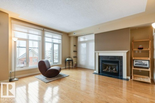 308 9020 Jasper Avenue, Edmonton, AB - Indoor Photo Showing Living Room With Fireplace
