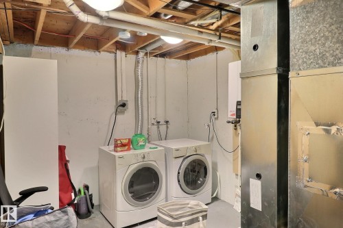 Basement Utility/Laundry Room W Tankless Hot water system . - 18285 84 Avenue, Edmonton, AB - Indoor Photo Showing Laundry Room