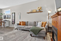 Living room featuring wood finished floors and a textured ceiling - 