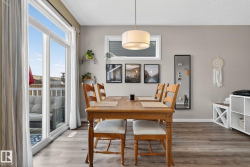 Dining room with wood finished floors and baseboards - 211 Sturtz Bend, Leduc, AB - Indoor Photo Showing Dining Room