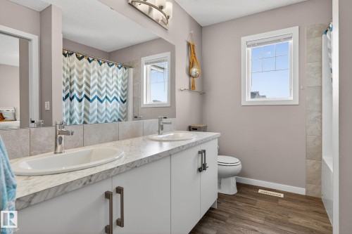 Bathroom featuring double vanity and dark wood finished floors - 211 Sturtz Bend, Leduc, AB - Indoor Photo Showing Bathroom