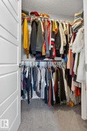 Walk in closet featuring light carpet - 