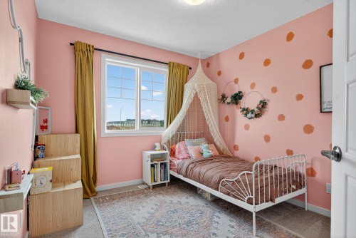Bedroom with a textured ceiling and wallpapered walls - 211 Sturtz Bend, Leduc, AB - Indoor Photo Showing Bedroom