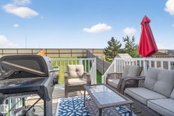 Deck featuring grilling area, a fenced backyard, and outdoor lounge area - 