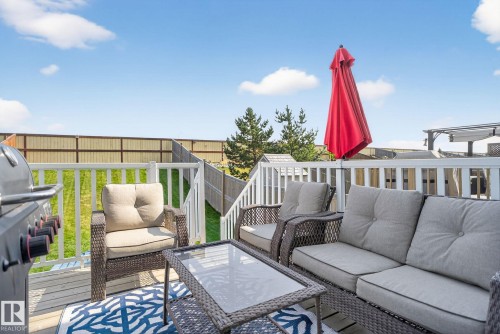 Wooden deck with grilling area and an outdoor lounge area - 211 Sturtz Bend, Leduc, AB - Outdoor With Deck Patio Veranda With Exterior