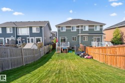 Back of property featuring a fenced backyard and a residential view - 