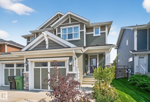 Craftsman-style house featuring stone siding and covered porch - 211 Sturtz Bend, Leduc, AB - Outdoor With Facade