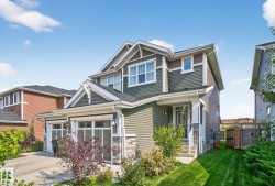 Craftsman house with stone siding and an attached garage - 