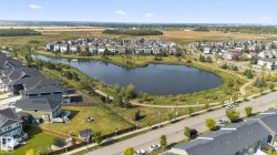 Aerial view of property and surrounding area with nearby suburban area and a nearby body of water - 
