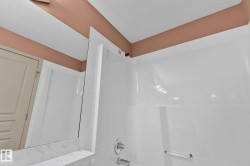 Full bath with a textured ceiling and tub / shower combination - 