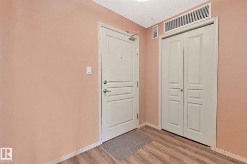 Entryway with a textured ceiling and light wood-style flooring - 406 16035 132 Street Nw, Edmonton, AB - Indoor Photo Showing Other Room