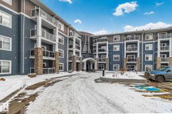 Snow covered building with a view of apartment building / complex - 