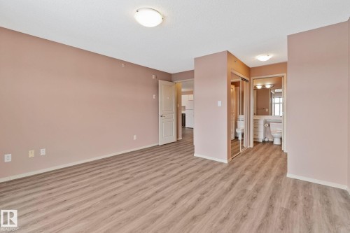 Empty room featuring light wood-type flooring and baseboards - 406 16035 132 Street Nw, Edmonton, AB - Indoor Photo Showing Other Room
