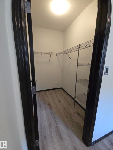 Walk in closet with light wood-style flooring - 106 10531 117 Street, Edmonton, AB - Indoor
