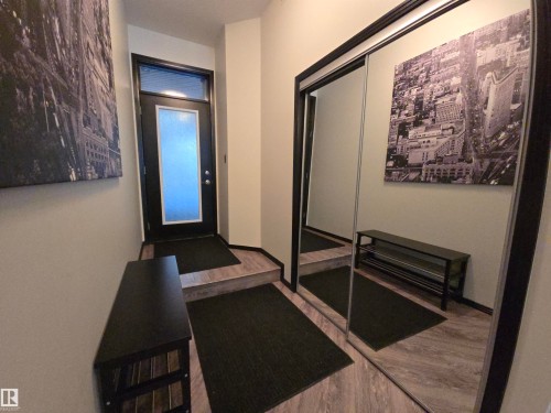 Hall featuring wood finished floors - 106 10531 117 Street, Edmonton, AB - Indoor Photo Showing Other Room