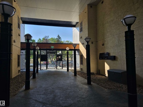 Doorway to property featuring a gate, stucco siding, and a patio - 106 10531 117 Street, Edmonton, AB -  Photo Showing Other Room