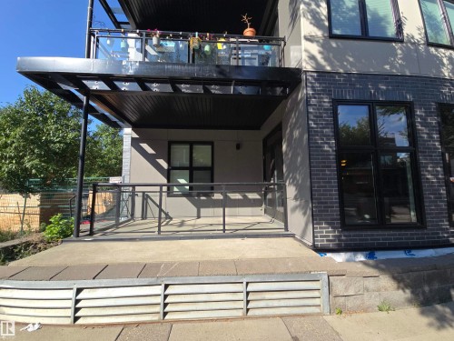 Doorway to property featuring brick siding, a patio area, and stucco siding - 106 10531 117 Street, Edmonton, AB - Outdoor