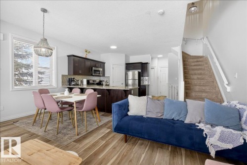 Dining room with light wood-style floors and a textured ceiling - 12761 119 St, Edmonton, AB - Indoor