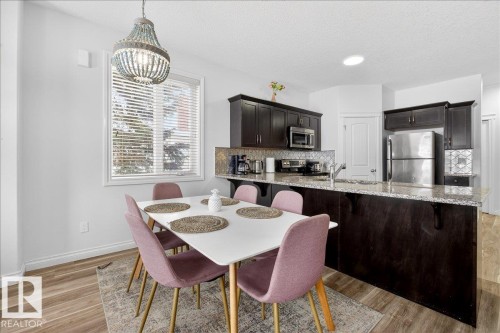 Dining room with a textured ceiling and light wood-type flooring - 12761 119 St, Edmonton, AB - Indoor