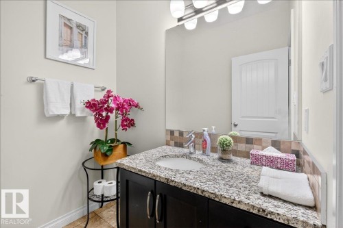 Bathroom with vanity and light tile patterned flooring - 12761 119 St, Edmonton, AB - Indoor Photo Showing Bathroom