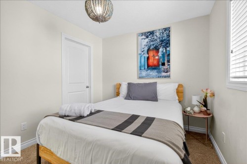 Carpeted bedroom featuring baseboards - 12761 119 St, Edmonton, AB - Indoor Photo Showing Bedroom