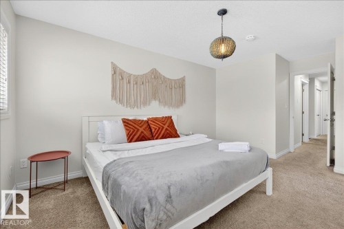 Carpeted bedroom with a textured ceiling - 12761 119 St, Edmonton, AB - Indoor Photo Showing Bedroom