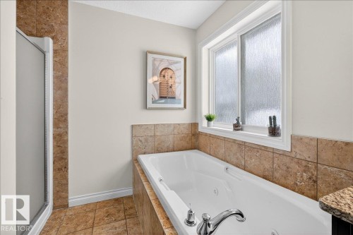 Bathroom with a whirlpool tub and a stall shower - 12761 119 St, Edmonton, AB - Indoor Photo Showing Bathroom