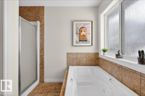 Bathroom with a shower stall and a garden tub - 12761 119 St, Edmonton, AB - Indoor Photo Showing Bathroom